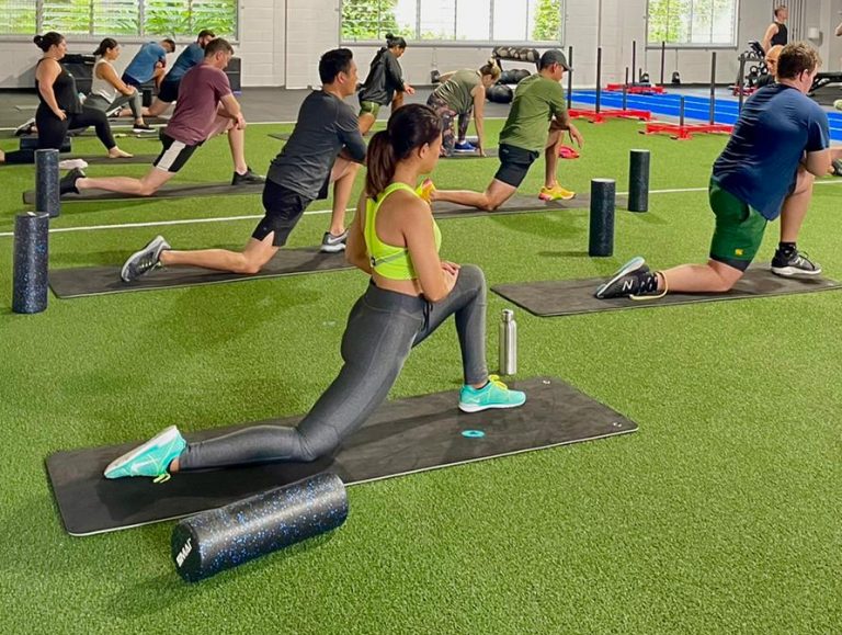 ATHLETIX coach guiding a participant through a session