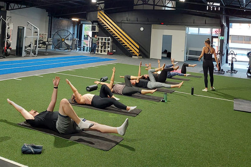 Mat Pilates class on the turf at ATHLETIX Brisbane